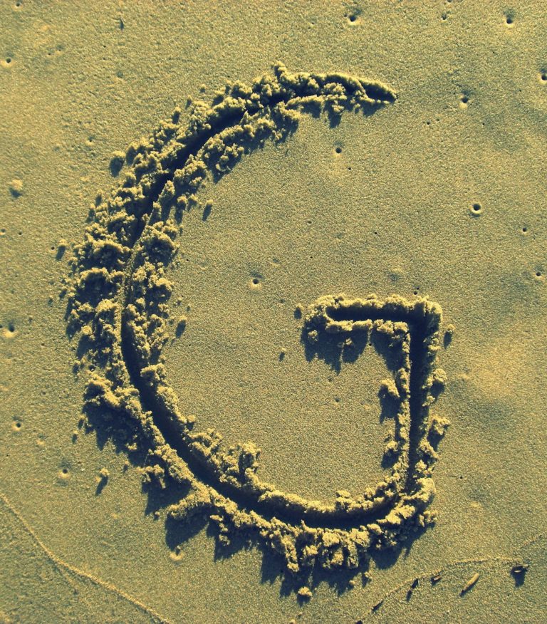 letter g, sand, stick