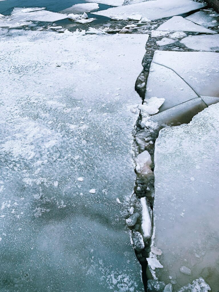 A striking image of a cracked ice surface on a frozen body of water.