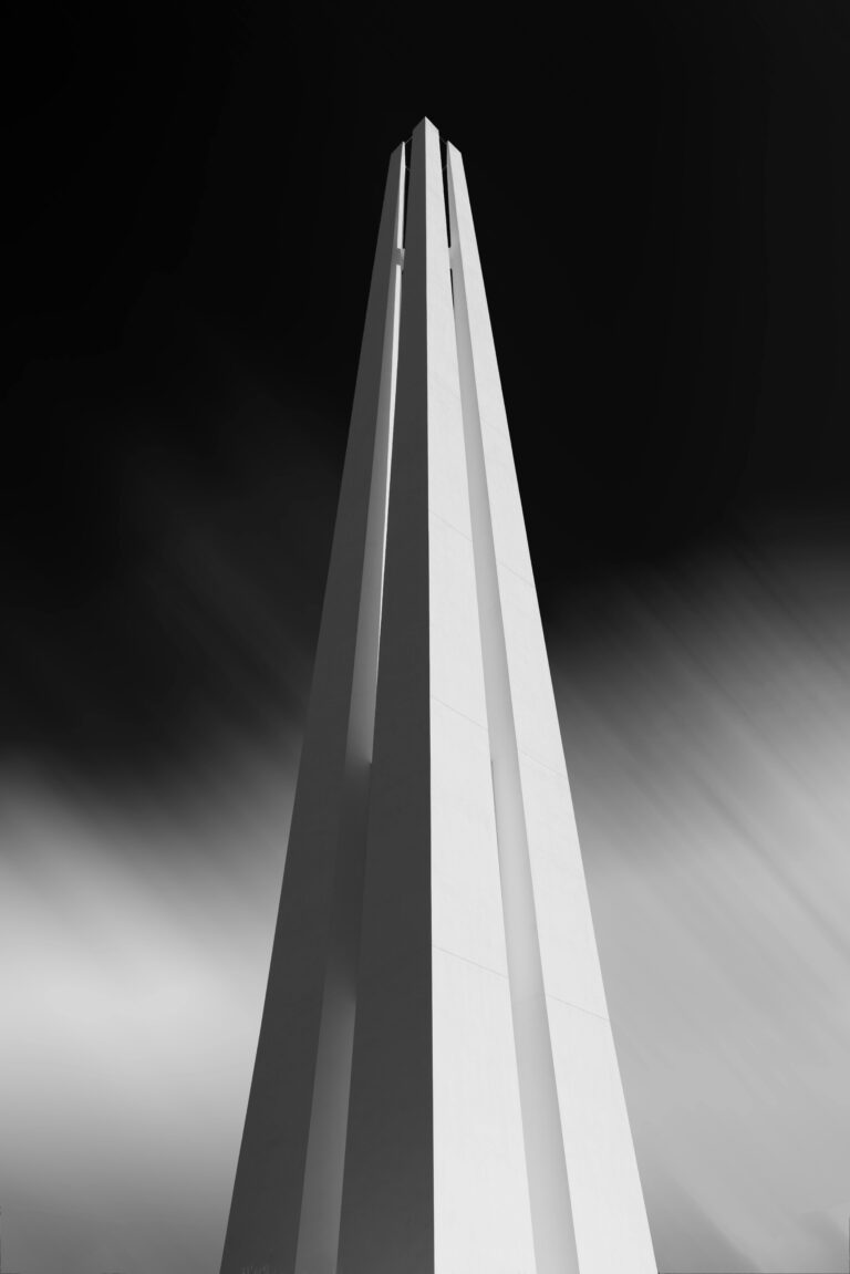 Elegant black-and-white photo of a war memorial tower in Singapore.