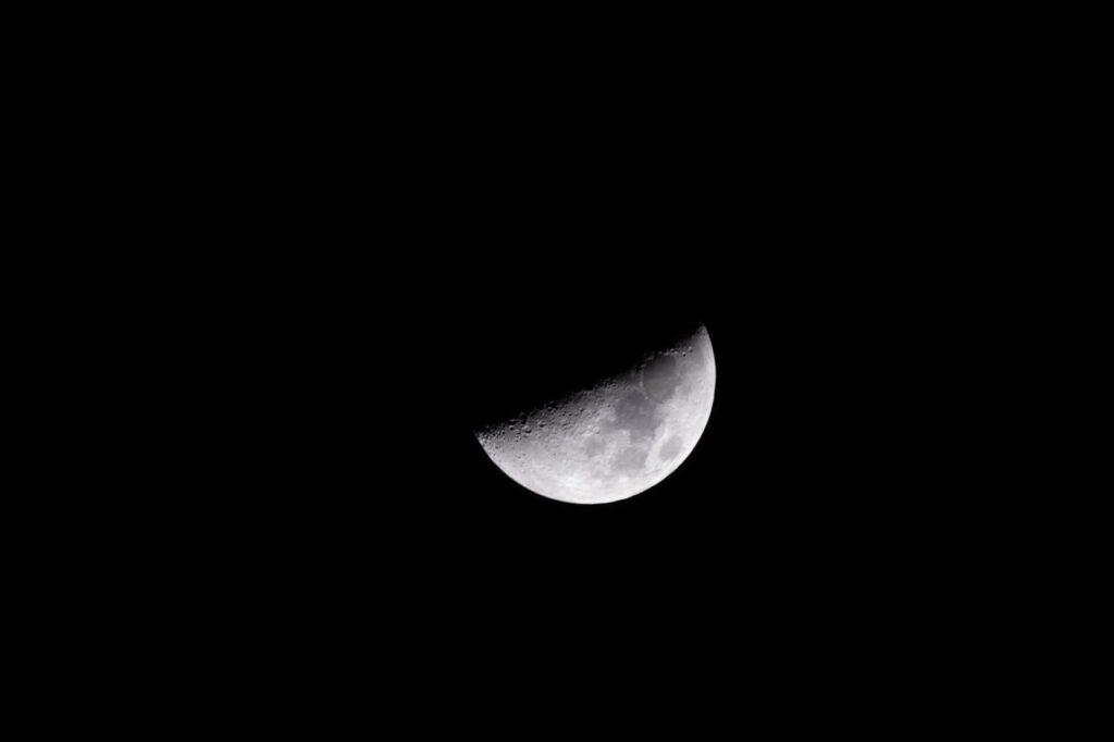 Detailed capture of the waxing gibbous moon against a black sky, highlighting lunar textures.